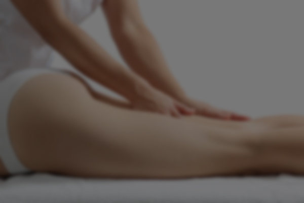 Side view of a woman legs receiving a massage therapy